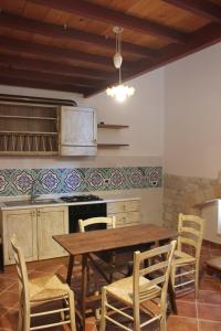 a kitchen with a wooden table and chairs at Case Vacanza ARCO SANT'ANTONIO in Bisceglie