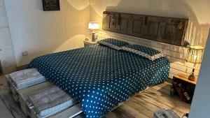 a bedroom with a large bed with polka dot sheets at La dimora di zio Nino in Martina Franca