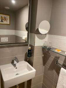 a bathroom with a sink and a mirror at XO Hotel Paris in Paris