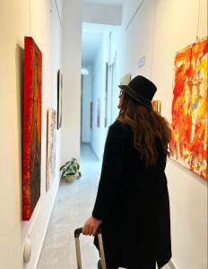 a woman is looking at art in a hallway at Il vecchio Fauno in Pompei