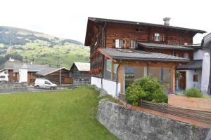 a house on a hill with a green yard at Casa Fausta Capaul in Brigels