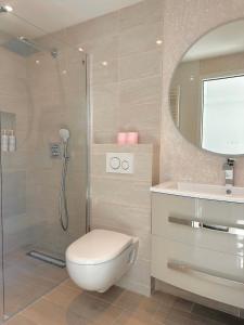 a bathroom with a shower and a toilet and a sink at RIVIERA Appart'hôtel Panoramique in Cap d'Ail