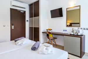 a hotel room with a bed and a desk at White Olive Premium Laganas in Laganas