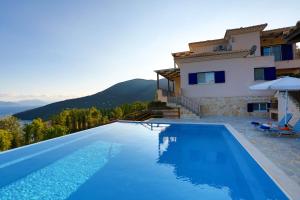 a villa with a swimming pool and a house at Villa Columba - Luxury Private Villa in Modern Residence in Sivota