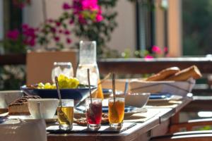 a table topped with plates of food and drinks at Villa Giancarlo - Lovely Villa with Stone and Wood Elements in Sivota Bay in Sivota