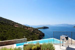 a swimming pool with a view of the ocean at VILLAS MIRO - Luxury Villas with Direct Sea Access for 14 people in Sivota