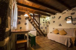 a bedroom with a bed and a staircase in a room at Casa Rural De Piedra in Frontera