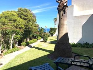 a statue of a bird sitting on top of a tree at The Albufeira Concierge - Moinho Pool & Gardens in Albufeira
