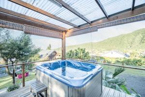 a hot tub on the balcony of a house at Ti chalet toto in Saint-Louis