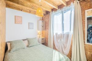 a bedroom with a bed and a large window at Ti chalet toto in Saint-Louis