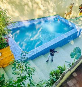 an overhead view of a swimming pool with a person in it at New Green Hill in Matheran
