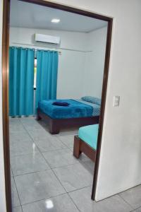 a mirror in a room with two beds in it at Cahuita Apartment by Angie in Cahuita
