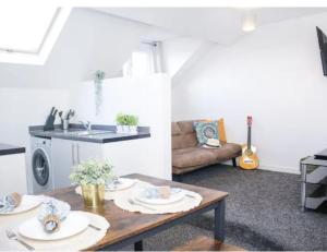 a living room with a table and a couch at Central Bliss 2BD Apt Near Transport Links in Liverpool