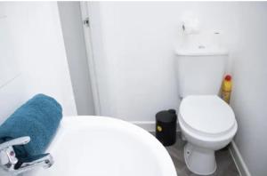 a bathroom with a white toilet and a blue towel at Central Bliss 2BD Apt Near Transport Links in Liverpool