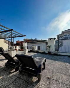 two chairs and a table on a patio at attico ARENA,200mq[NETFLIX-WIFI-AIR CONDITIONING] in Verona +16 photos