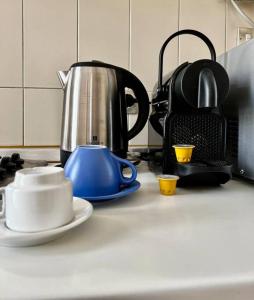 a kitchen counter with a tea kettle and cups on it at attico ARENA,200mq[NETFLIX-WIFI-AIR CONDITIONING] in Verona