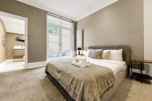 Un dormitorio con una cama grande y una ventana en Mayfair Apartment with Private Terrace!, en Londres