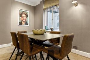 a dining room with a table and chairs at Mayfair Apartment with Private Terrace! in London