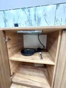 a wooden cabinet with a bowl and a sink in it at Freedom hotel in Almaty