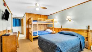 a bedroom with two beds and a bunk bed at The Inn at the Rostay in Bethel