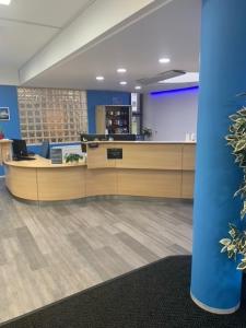 an office with a reception desk and a blue wall at Broadview Lodge in Norwich