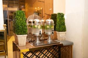 a table withurgers and potted plants on it at Lamar Ajyad First Hotel Tower B in Mecca