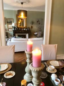 a dining room with two candles on a table at Au 16 Place Saint Louis in Blois