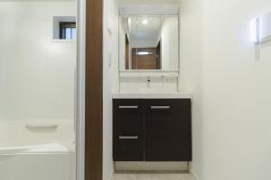 a bathroom with a sink and a mirror at QiQi Serenity Tokyo Exclusive New 3-Story Home, 14min to Skytree, Asakusa Area in Tokyo +30 photos
