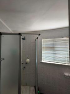 a shower with a glass door in a bathroom at Strictly-Halaal Holiday Home at Meerensee Resort in Fisherhaven
