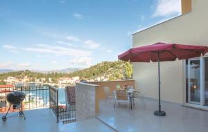 a patio with a table and an umbrella on a balcony at Villa Nostra vita in Blace