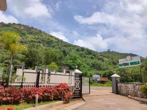 a gate at the entrance to a hotel with a mountain at HOTEL NATURE SHIELD in Lonavala