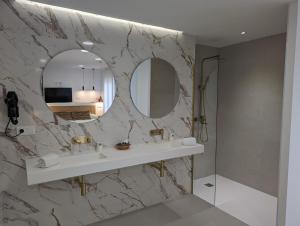 a bathroom with a sink and a mirror at Gran Hotel Toledo in Onda +129 photos