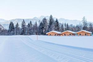 a snow covered road in front of a ski lodge at Austria Parks - Leutasch in Leutasch