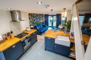 a kitchen with blue cabinets and a blue couch at No 33 Cottage 2 in Thornham
