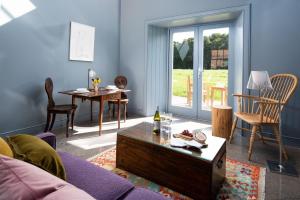 a living room with a couch and a table at Shepherd's Bothy at Papple Steading in East Linton