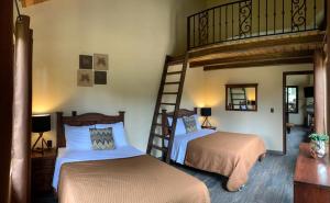 a bedroom with two bunk beds and a ladder at Cabaña No.2 Puerta del Bosque Mazamitla. in Mazamitla +8 photos