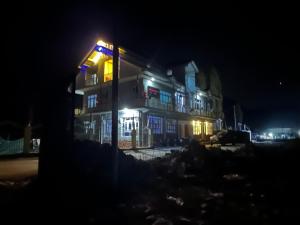 a lit up building at night with at D’SHIEKHS RESORT GUREZ in Kanzalwan