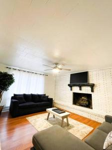 a living room with a couch and a fireplace at Hidden GEM W1 king bed &2 queens in Winston-Salem