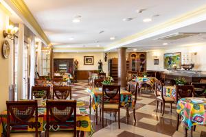 a restaurant with tables and chairs in a room at Hotel Avenida Tropical by Bossh! Hotels in Salobreña