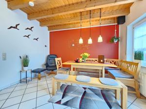 a dining room with a table and chairs at Ferienhaus Nordseekrabbe in Norden