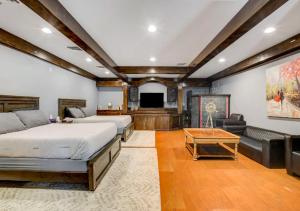a bedroom with two beds and a flat screen tv at Luxurious 9 Bedroom Home In Las Vegas in Las Vegas