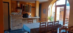 eine Küche und ein Esszimmer mit einem Tisch und Stühlen in der Unterkunft La Forge De Labbaye in Liessies