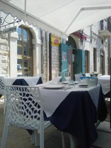 a table with a blue and white table cloth on it at LITHOS guest room in Barletta