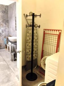 a bathroom with a towel rack and a toilet at Sweethouse in Cesena