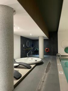 a bathroom with a tub and a swimming pool at Stylist Apartment Heart of Brossard Dix30 in Brossard