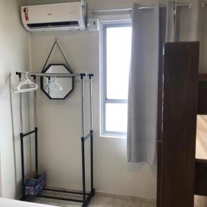 a room with a heater and a window at Kitnet 1102 - Apartamento para temporada in Recife