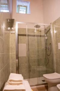 a bathroom with a shower and a toilet at LITHOS guest room in Barletta