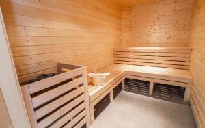 a sauna with a bench and a toilet at Haus Tauernblick Katschberg by AlpenTravel in Katschberghöhe