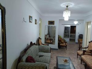 a living room with a couch and a table at The sea apartment in ‘Izbat al Qaşr