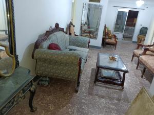 a living room with a couch and a coffee table at The sea apartment in ‘Izbat al Qaşr